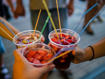 Close-up of hands holding drinks