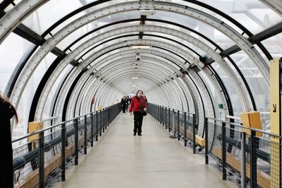 Rear view of man walking in corridor