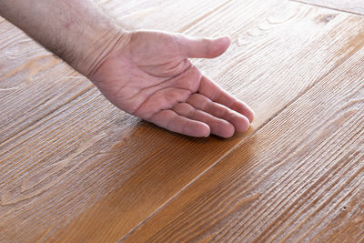 Close-up of hand on table