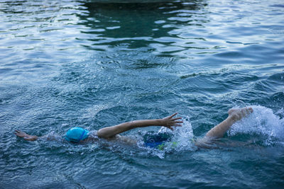 High angle view of boy swimming in lake