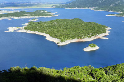 High angle view of trees by sea against sky