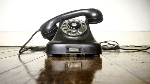 Close-up of old telephone on table