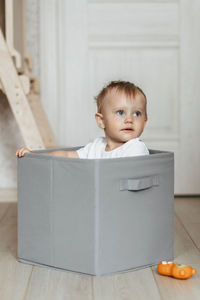 Portrait of cute baby boy sitting on chair