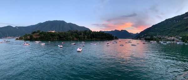 Scenic view of sea and mountains against sky