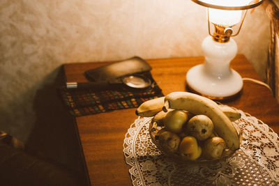 High angle of fruit and retro lamp on the table