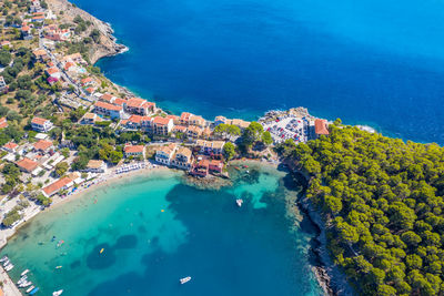 High angle view of swimming pool by sea against city