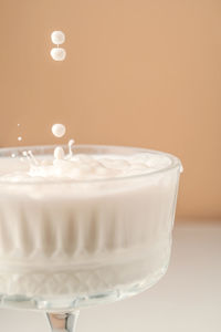 Milk pours into a beautiful crystal glass and splashes around.