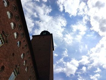 Low angle view of building against cloudy sky