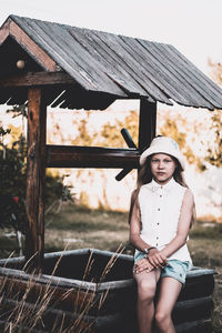 Portrait of girl wearing hat on wood
