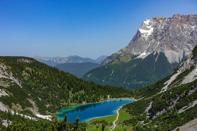 Scenic view of mountains against clear blue sky