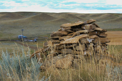 Hay bales on field against sky