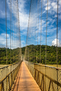 Suspension iron cable bridge isolated with bright blue sky from unique different angle