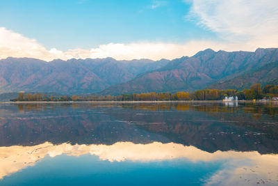 Scenic view of lake and mountains against sky