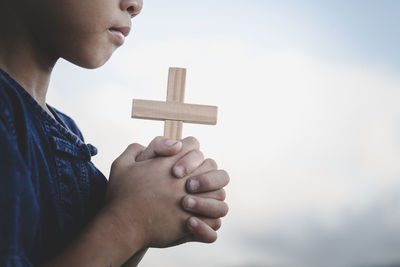 Close-up of man holding cross