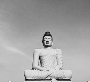 Portrait of a gauthama buddha sitting against wall