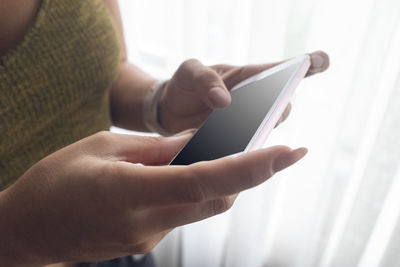 Midsection of man using mobile phone