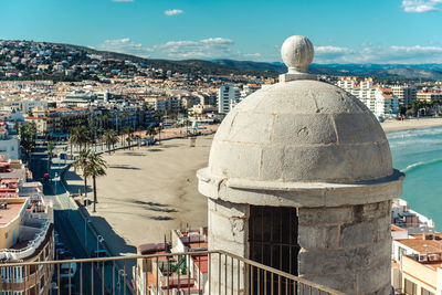 High section of castillo de peniscola against beach during sunny day