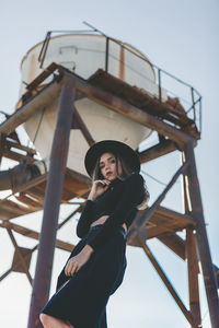Portrait of woman standing against sky
