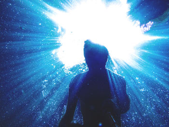 Rear view of man swimming in sea