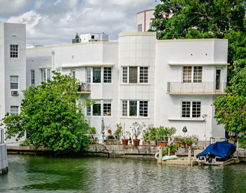 Buildings by river in city