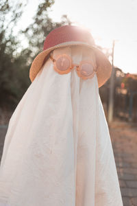 Trendy sheet ghosts costumes on little kids standing on a suburbs street. happy halloween holiday