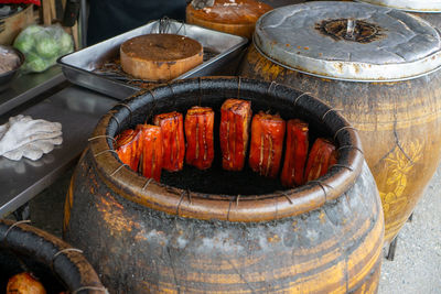 Clay barbecue charcoal pot with crispy pork belly in a restaurant kitchen