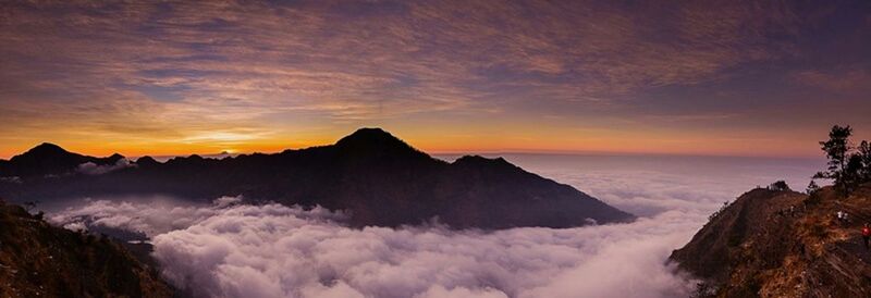 Scenic view of mountains against cloudy sky