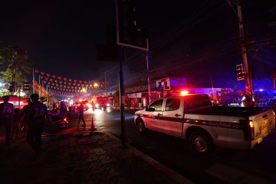 Cars on city street at night