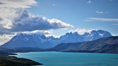 Scenic view of sea and mountains against sky