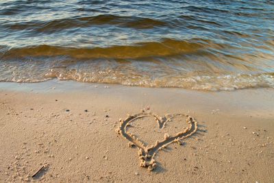 Heart drawn in sand of beach