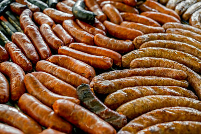 Fresh sausages cooking on grill for summer party