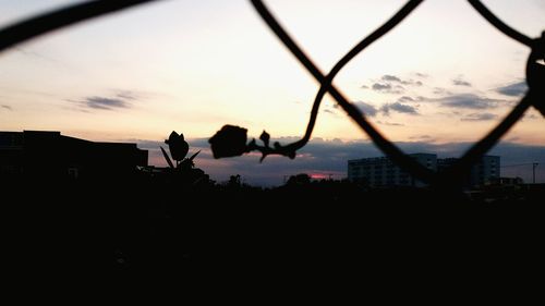 Silhouette of buildings against sky during sunset