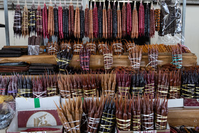 Various clothes hanging in store for sale in market
