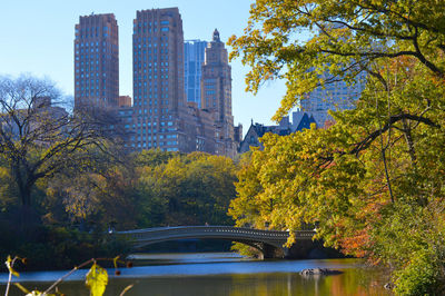 Bridge over river amidst buildings in city