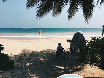 Man standing on beach against clear sky