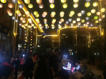 Group of people in illuminated building at night