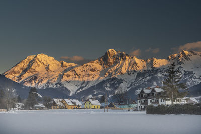 Scenic view of snowcapped mountains against sky during sunset