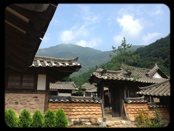 Houses against mountain range