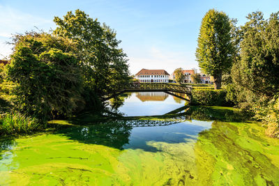 Scenic view of lake by building against sky