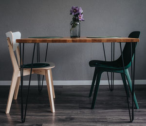 Empty chairs and table against wall at home