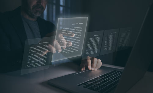 Midsection of businessman using laptop