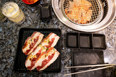 High angle view of meat on barbecue grill