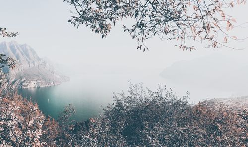 Scenic view of lake against sky during winter