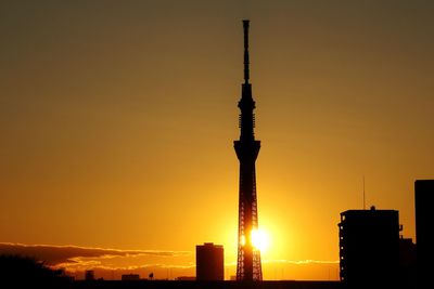 Silhouette of communications tower at sunset