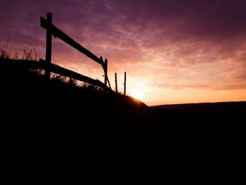 Silhouette landscape against sky during sunset