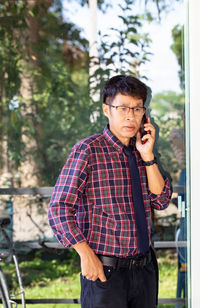 Young man wearing sunglasses standing outdoors