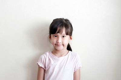 Portrait of a smiling girl over white background