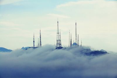 Clouds covering landscape against communications towers