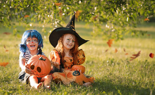 Boy and girl in carnival costumes celebrate halloween