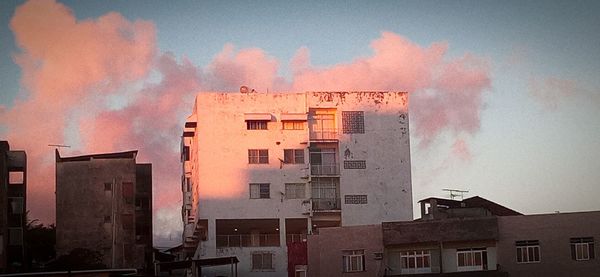 Low angle view of buildings against sky during sunset